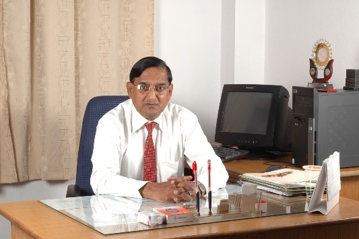 Dr. V. K. Lal seated at his desk